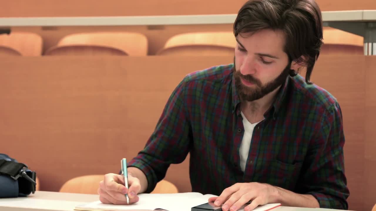 Focused student taking down notes