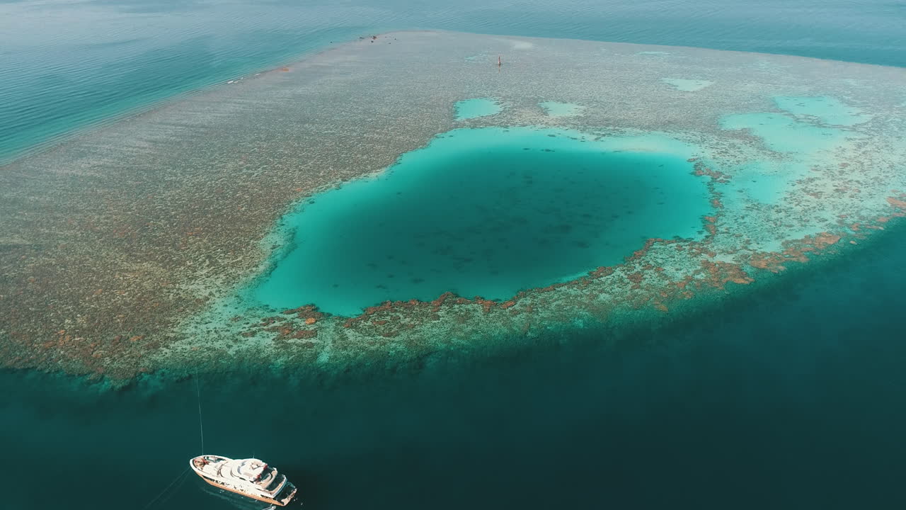 Aerial Shot for the Red Sea of Egypt in the North beside Hurghada with the drone moving forward towards a light house on a coral island of Abu Nuhas Coral island