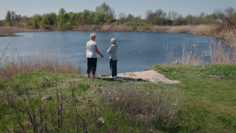 two women talking by a lake