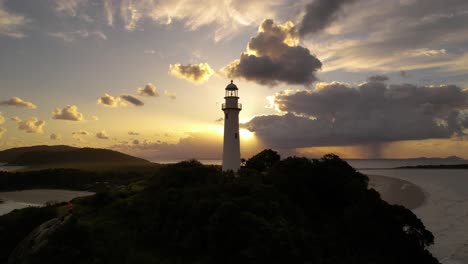 lighthouse on the beach at sunset