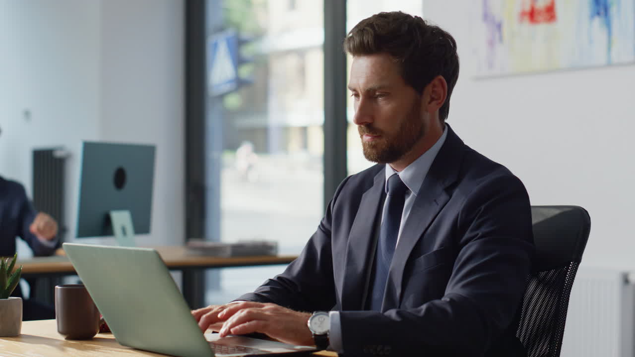 Focused entrepreneur working laptop at coworking closeup. Man closing computer