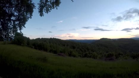 time lapse video over the sunset in the mountains.