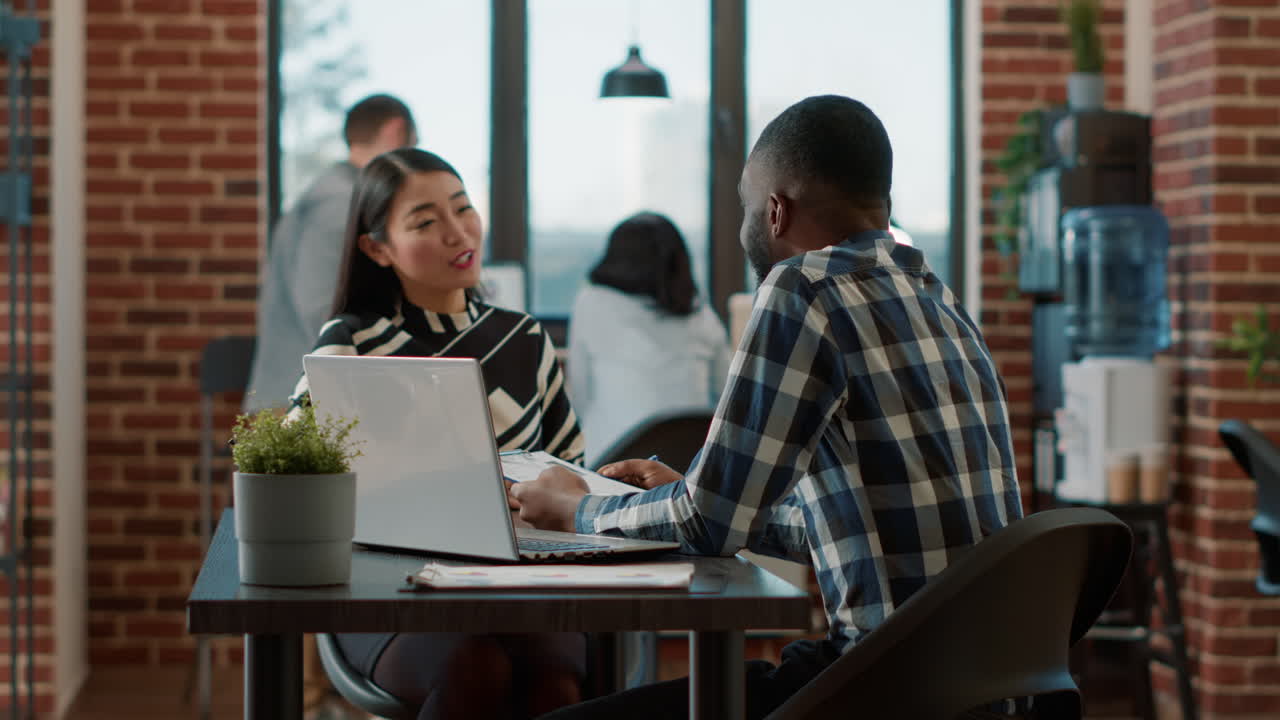 African american recruiter greeting asian woman at job interview