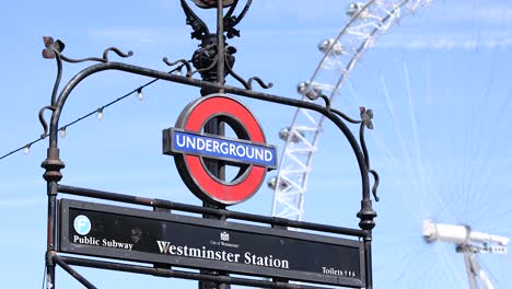 westminster station sign with london eye background