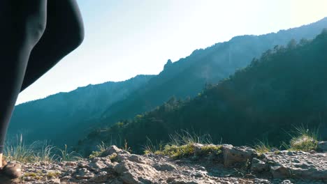 view on feet of traveler woman hiking walking on the top of cliff in mountain. walking on rocks