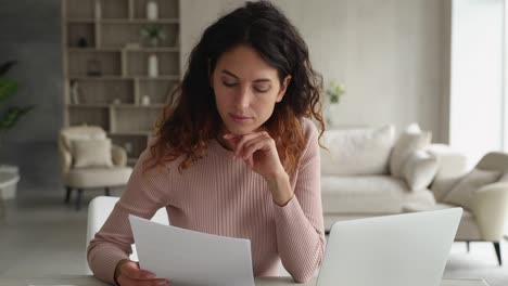 businesswoman sit at desk do paperwork analyzing information makes research