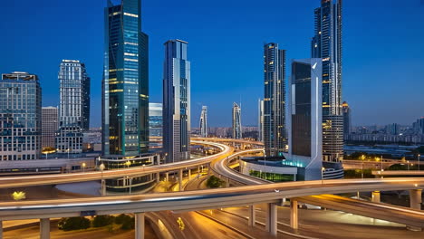 modern cityscape at night with skyscrapers and highway interchanges