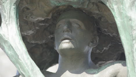 closeup of a bronze figure in one of the trees surrounding the fountain