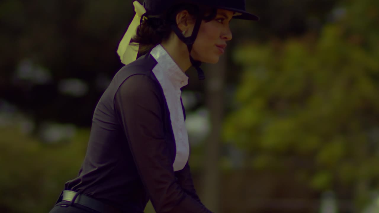 Happy female jockey on a competition day, slow motion