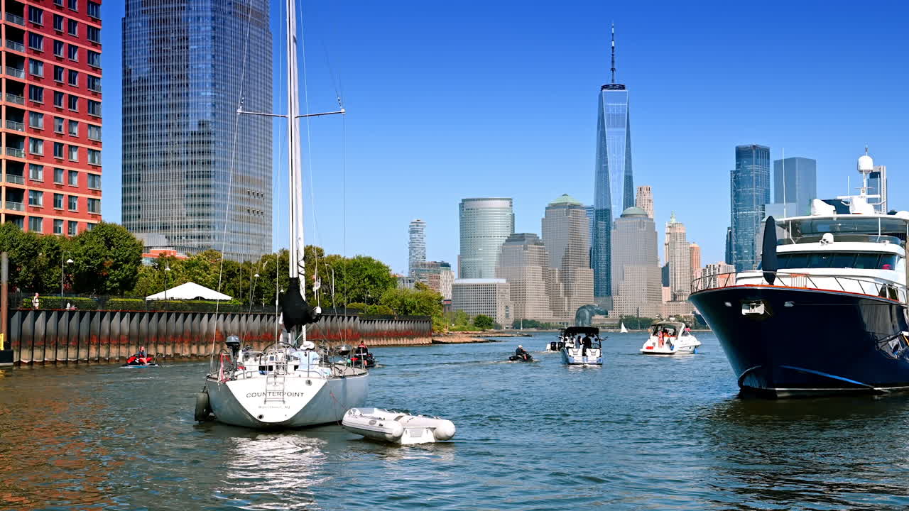 New Jersey, USA, 19 August 2025: Boats setting off from the berths in Jersey City. Skyscrapers and high-rises of Manhattan at backdrop