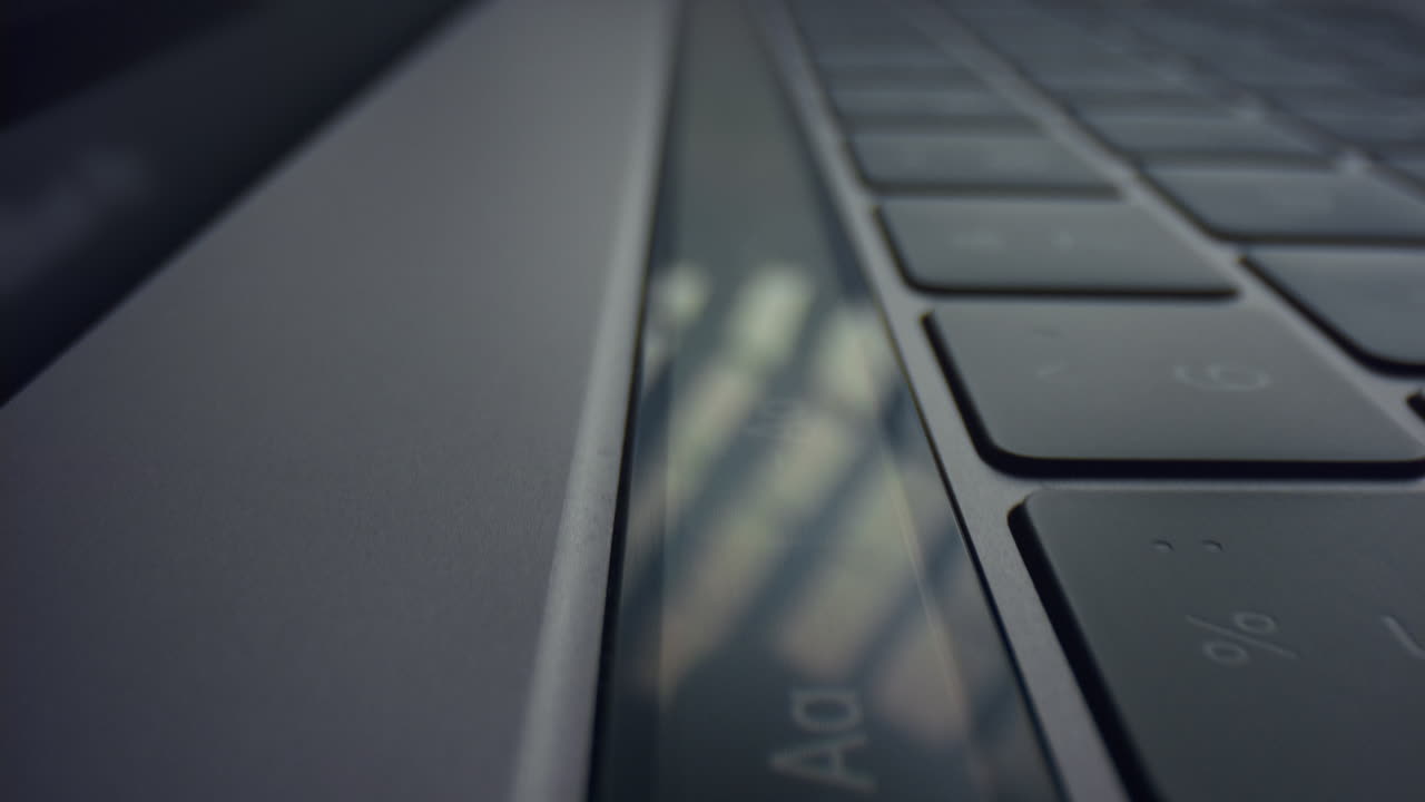 Male fingers pushing buttons on touch bar. Man hand using touch bar on laptop