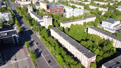 Savanoriai-street-and-apartment-buildings-on-sunny-day-in-Kaunas,-aerial