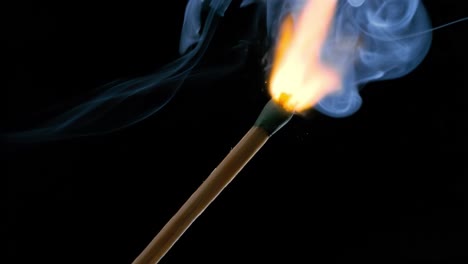 burning matchstick close-up on a dark background. shot on super slow motion camera 1000 fps.