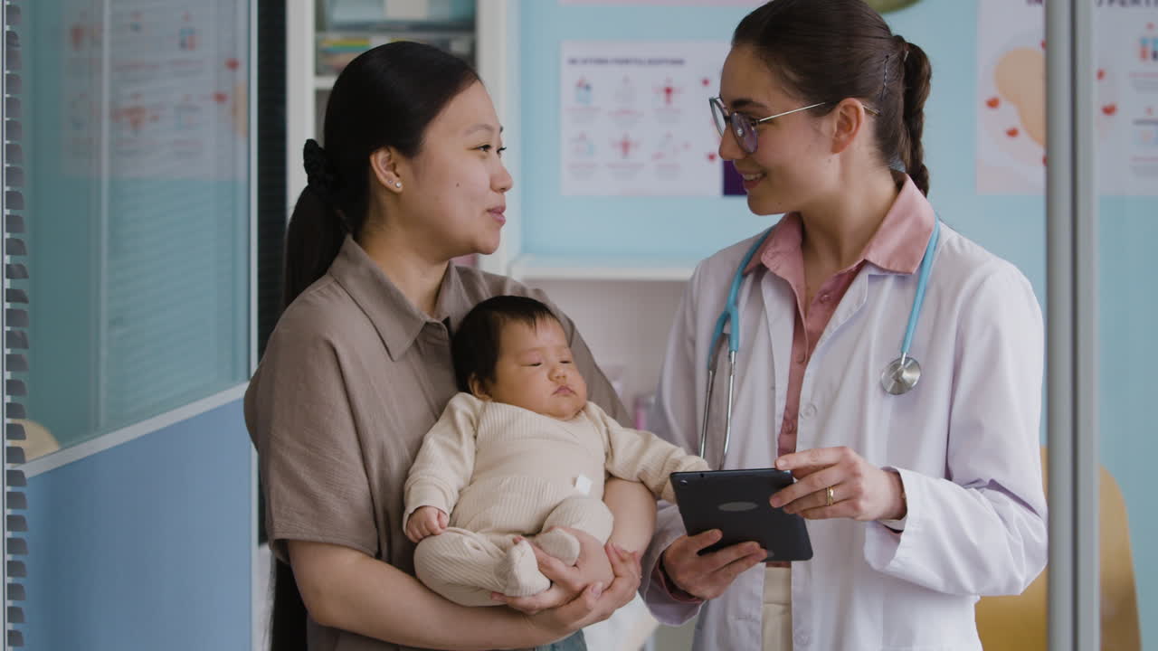 Doctor Consults with Mother and Baby