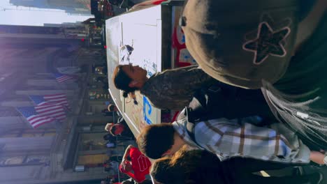 people writing graffiti on a truck during a protest in new york city