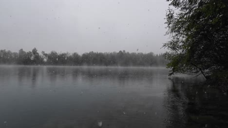 Snow-Flakes-are-falling-on-Mystical-Lake-with-Turquoise-Water-in-Europe