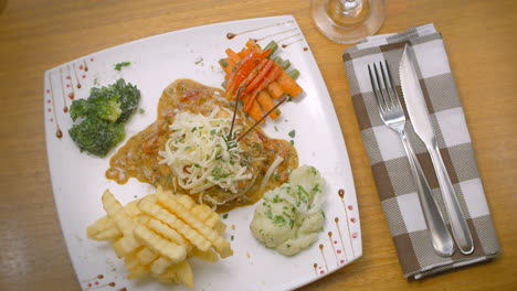 mustard chicken with french fries, salad, and grated cheese, mediterranean