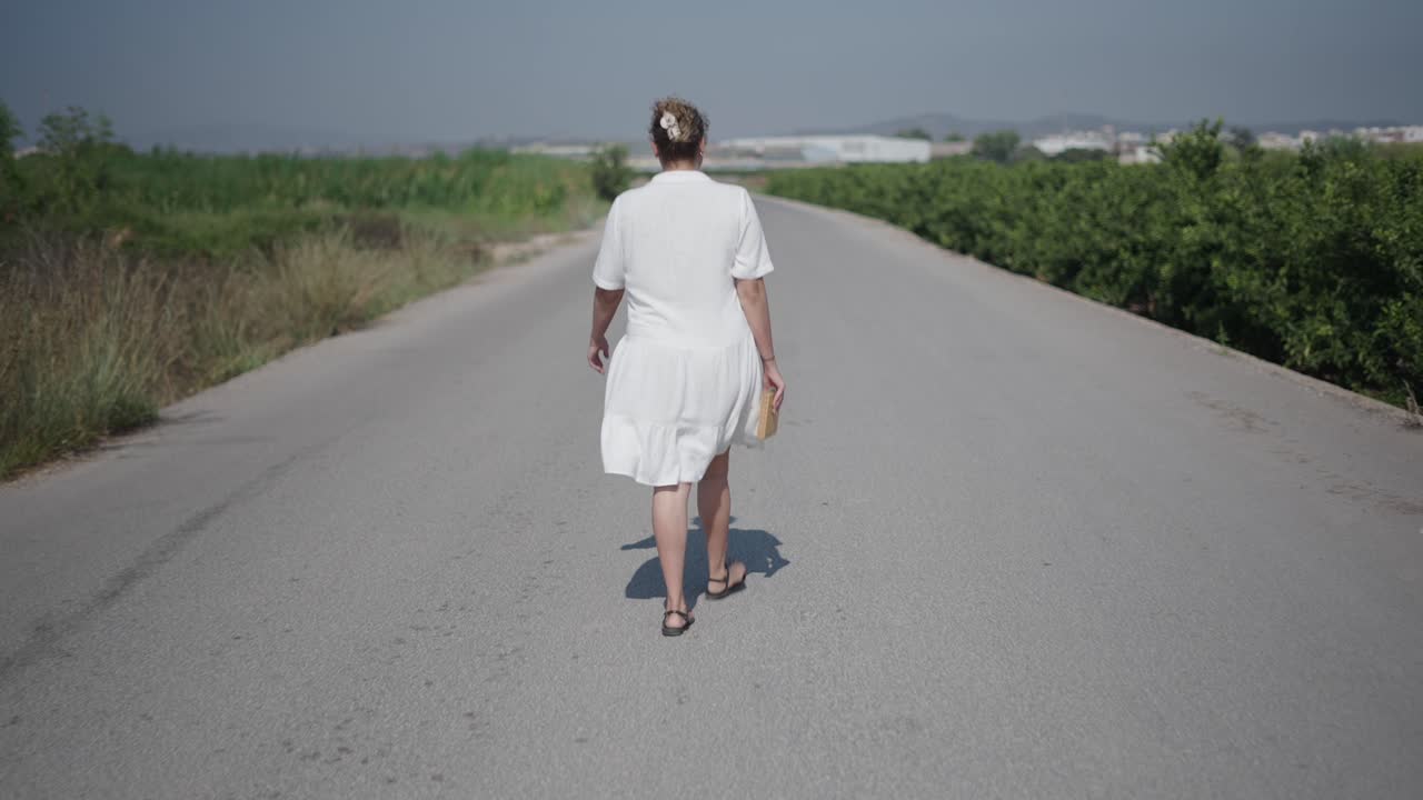 Woman Walking on a Country Road