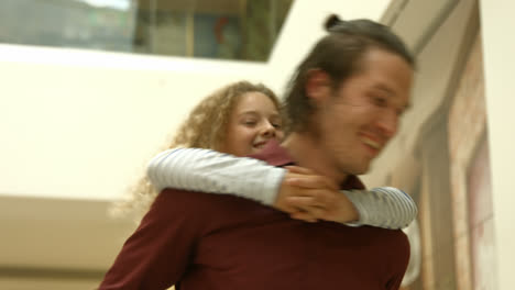 smiling father and daughter in piggyback