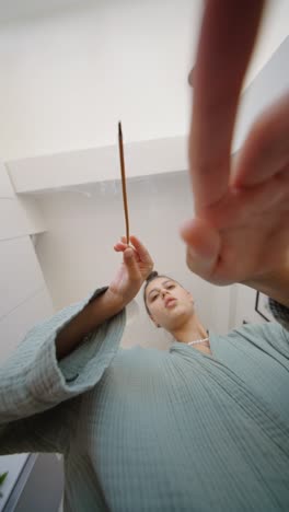 woman holding incense stick