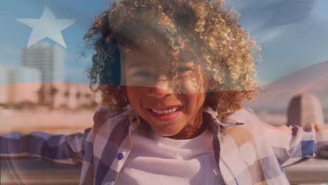 Animation-of-flag-of-chile-over-biracial-boy-smiling-at-seaside