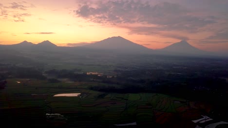 colorful sunrise behind the mountains in indonesia's natural landscape