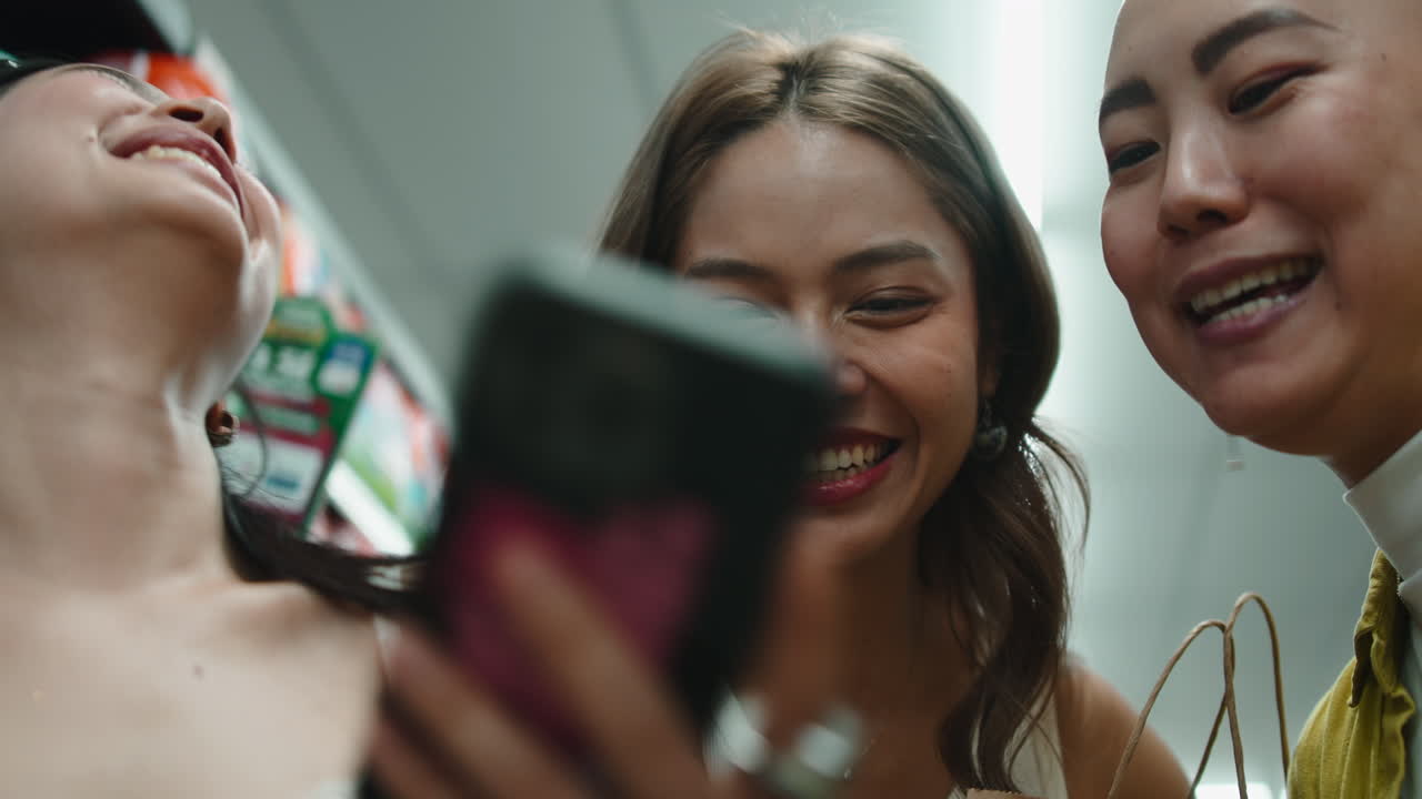 Friends shopping and looking at phone