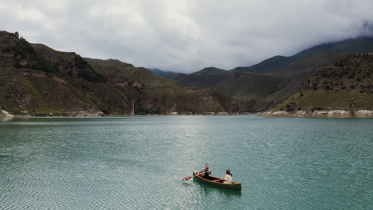 Coppia in kayak su lago di montagna