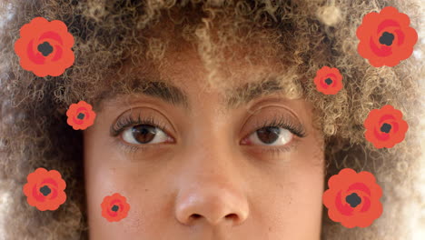 red flowers animation over close-up of person's face with curly hair