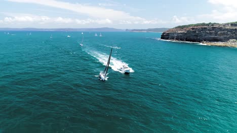 Slow-orbiting-aerial-shot-of-a-sail-boat-traveling-at-speed
