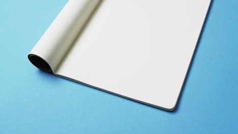 video of book with white blank pages and copy space on blue background