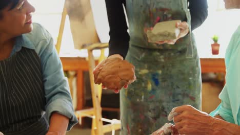 woman assisting artists in pottery 4k