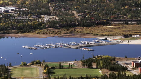 Lake-Dillon-Marina-Colorado-sailboats-early-fall-colors-yellow-Aspen-trees-aerial-cinematic-drone-morning-view-Frisco-Breckenridge-Silverthorne-Ten-Mile-Range-calm-reflective-water-circle-left-motion