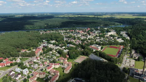 Cityscape-of-Birstonas-with-Nemumas-river-in-horizon,-aerial-drone-view