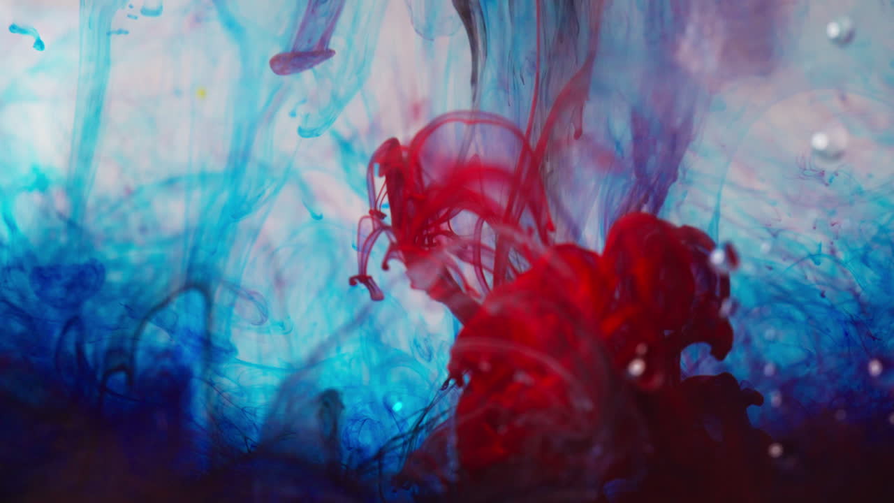 Vibrant ink swirling in water macro shot. Artistic and abstract mood