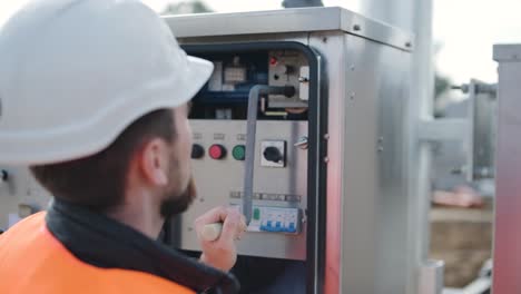 setting up equipment at a transformer substation. construction of a transformer substation