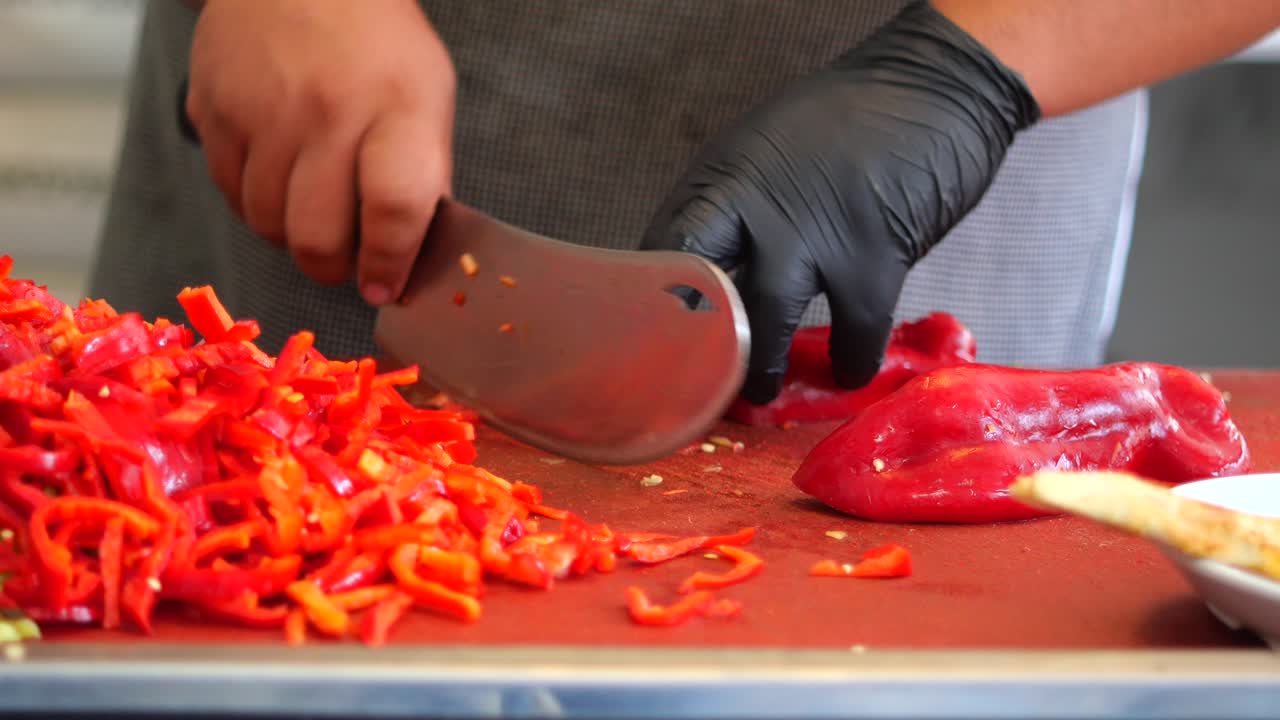 Chopping red bell peppers for cooking