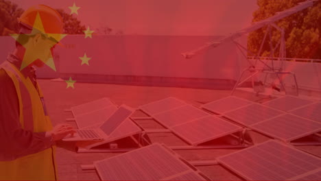 animation of flag of china over male engineer using tablet next to solar panels