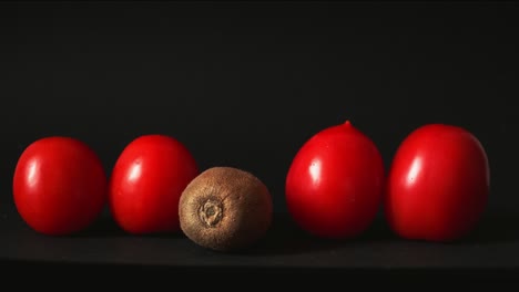 red fresh tomatoes on a black background