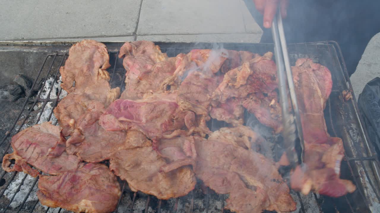 Juicy marinated meat grilling on open flame, street food vibe, in broad daylight, smoky and appetizing