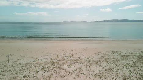 drone rising over sand bank at the beach