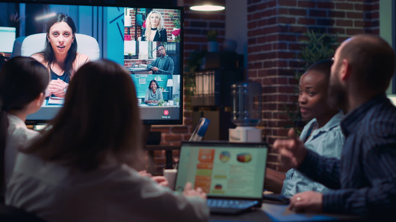 Employees talking with remote team in videoconference