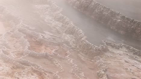 closeup of steam rising from a geothermal area in yellowstone national park