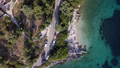 car driving on coastal road in mediterranean, high-angle above