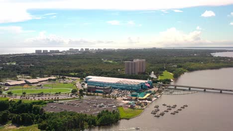 Very-high-aerial-view-of-Legendary-Marine,-the-mid-bay-bridge,-Destin-Middle-School,-and-Lulu's-seafood-restaurant