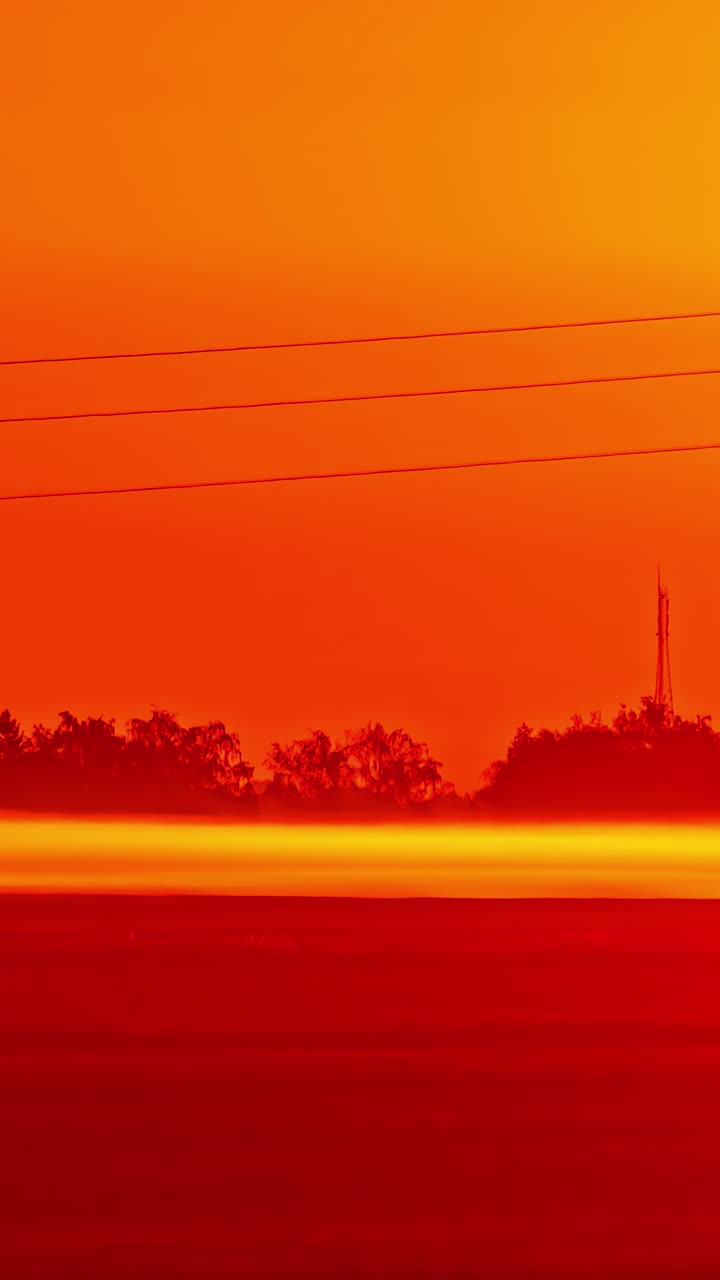 Timelapse of intense red sunset in vertical format, evokes awe and peace