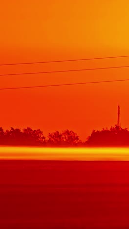 Timelapse of intense red sunset in vertical format, evokes awe and peace