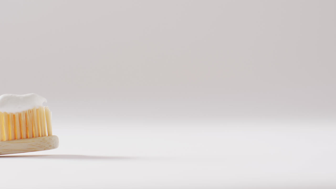 Close up of toothbrush with paste on white background with copy space