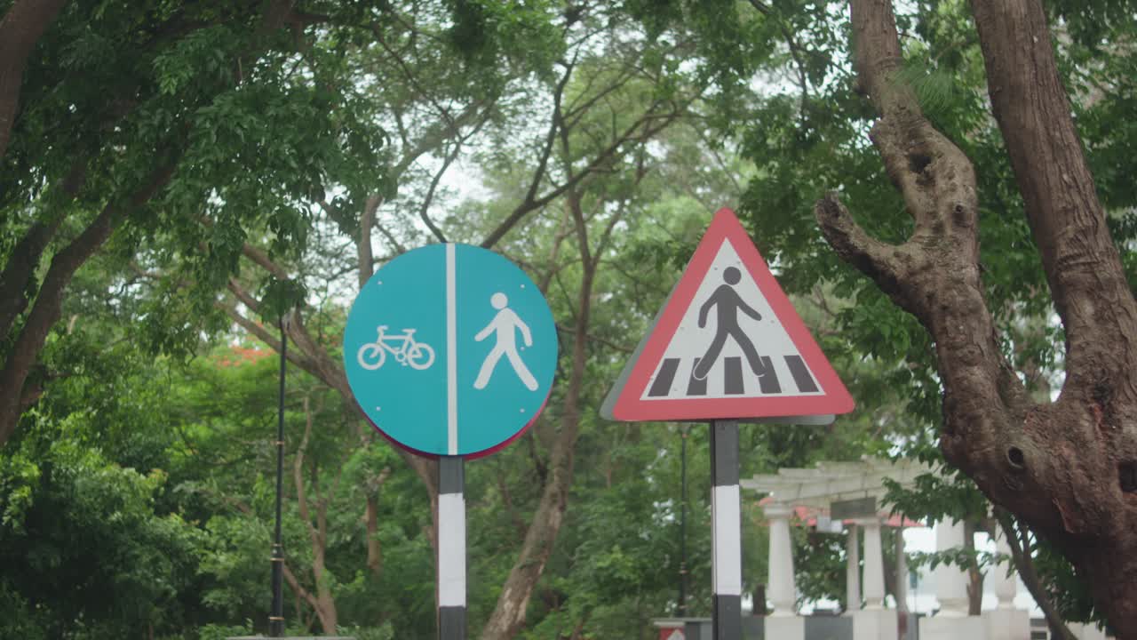Two road signs: one for shared pedestrian-cyclist path, one pedestrian warning sign
