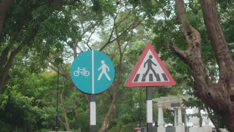 two road signs: one for shared pedestrian-cyclist path, one pedestrian warning sign
